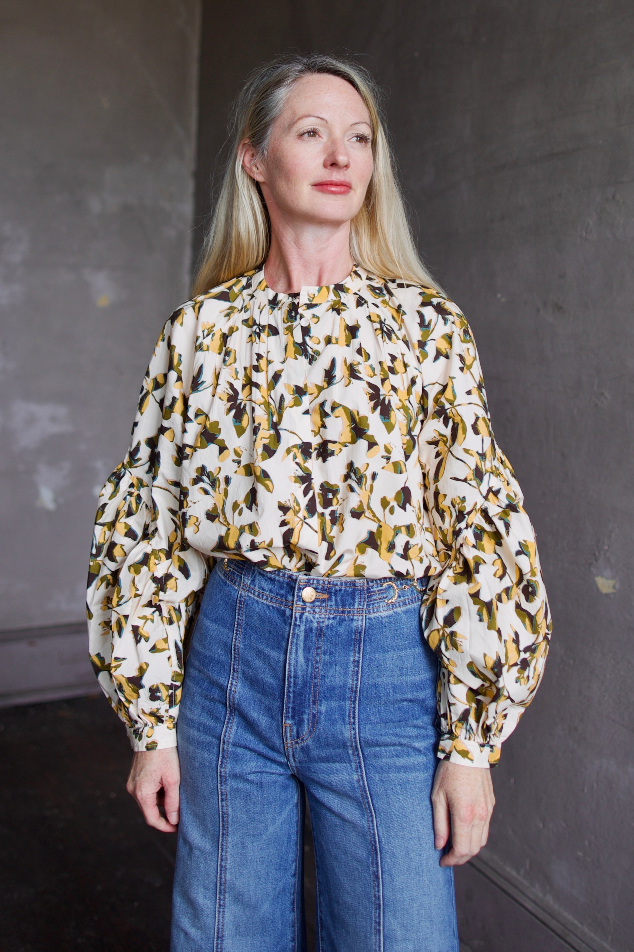 Image of mature woman wearing sophisticated Ulla Johnson Rowena Long Sleeve cotton poplin Blouse in Lucent cream with yellow and green floral print