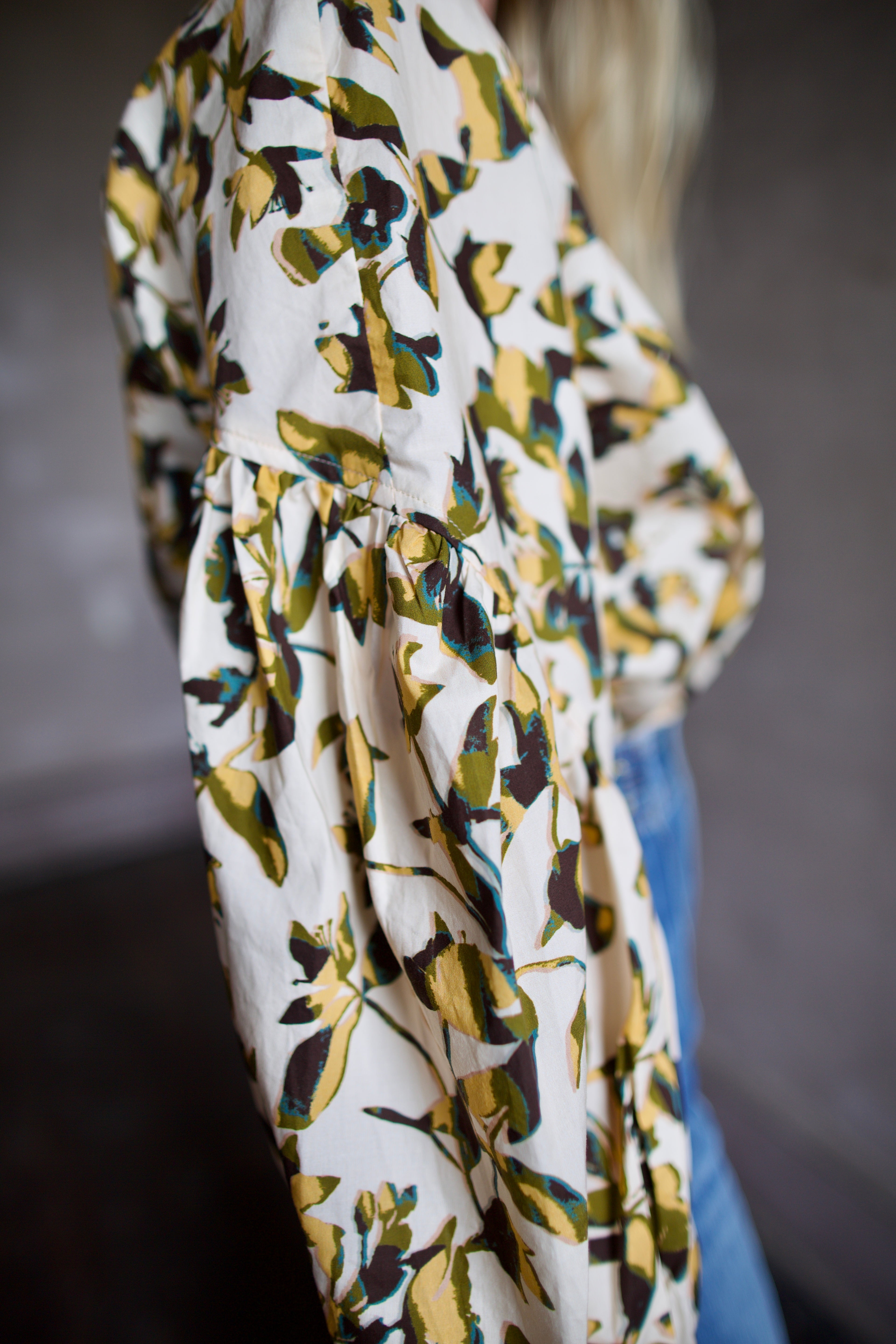 Image of mature woman wearing sophisticated Ulla Johnson Rowena Long Sleeve cotton poplin Blouse in Lucent cream with yellow and green floral print