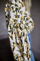 Image of mature woman wearing sophisticated Ulla Johnson Rowena Long Sleeve cotton poplin Blouse in Lucent cream with yellow and green floral print