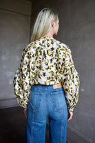 Image of mature woman wearing sophisticated Ulla Johnson Rowena Long Sleeve cotton poplin Blouse in Lucent cream with yellow and green floral print