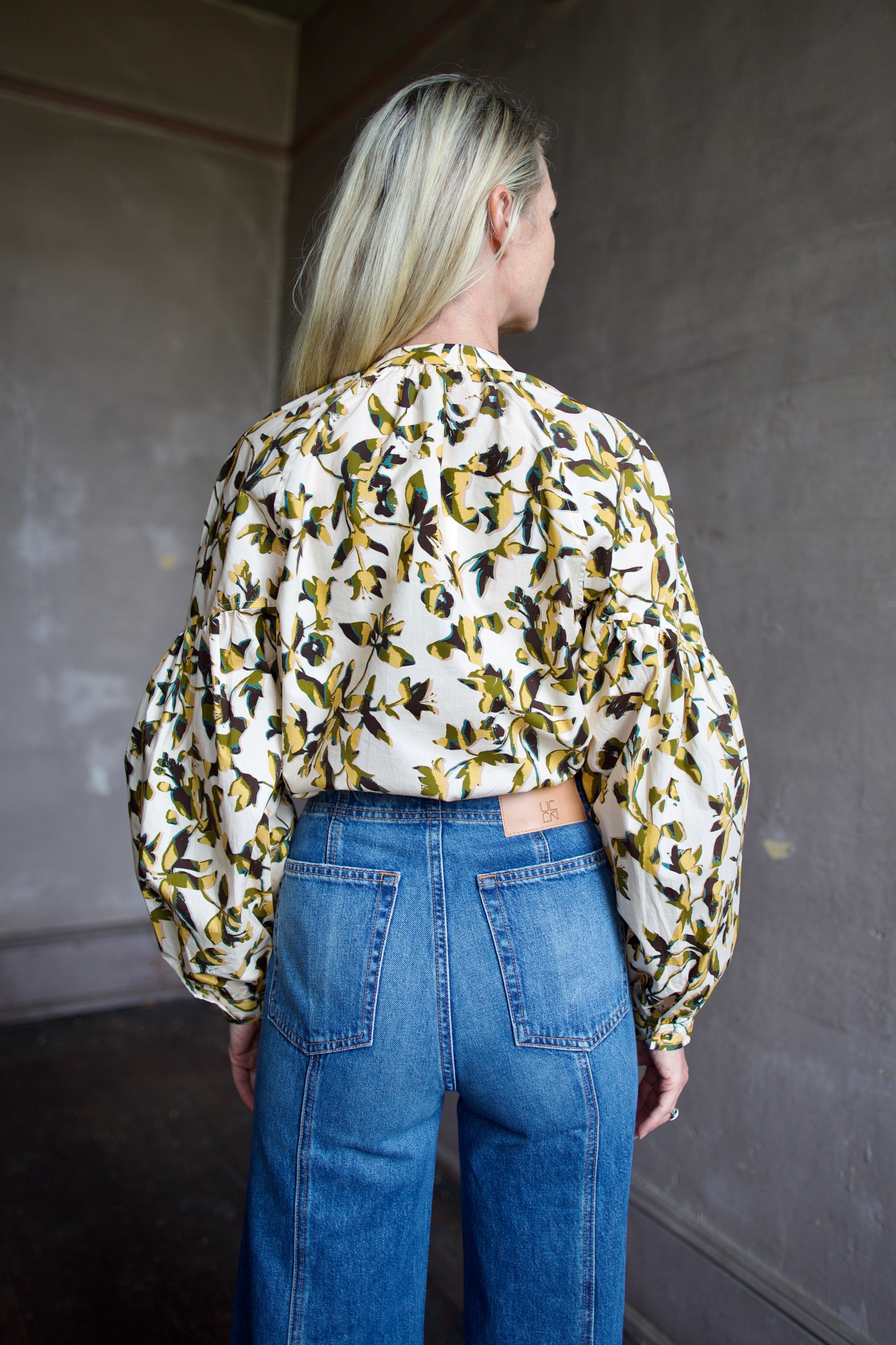 Image of mature woman wearing sophisticated Ulla Johnson Rowena Long Sleeve cotton poplin Blouse in Lucent cream with yellow and green floral print