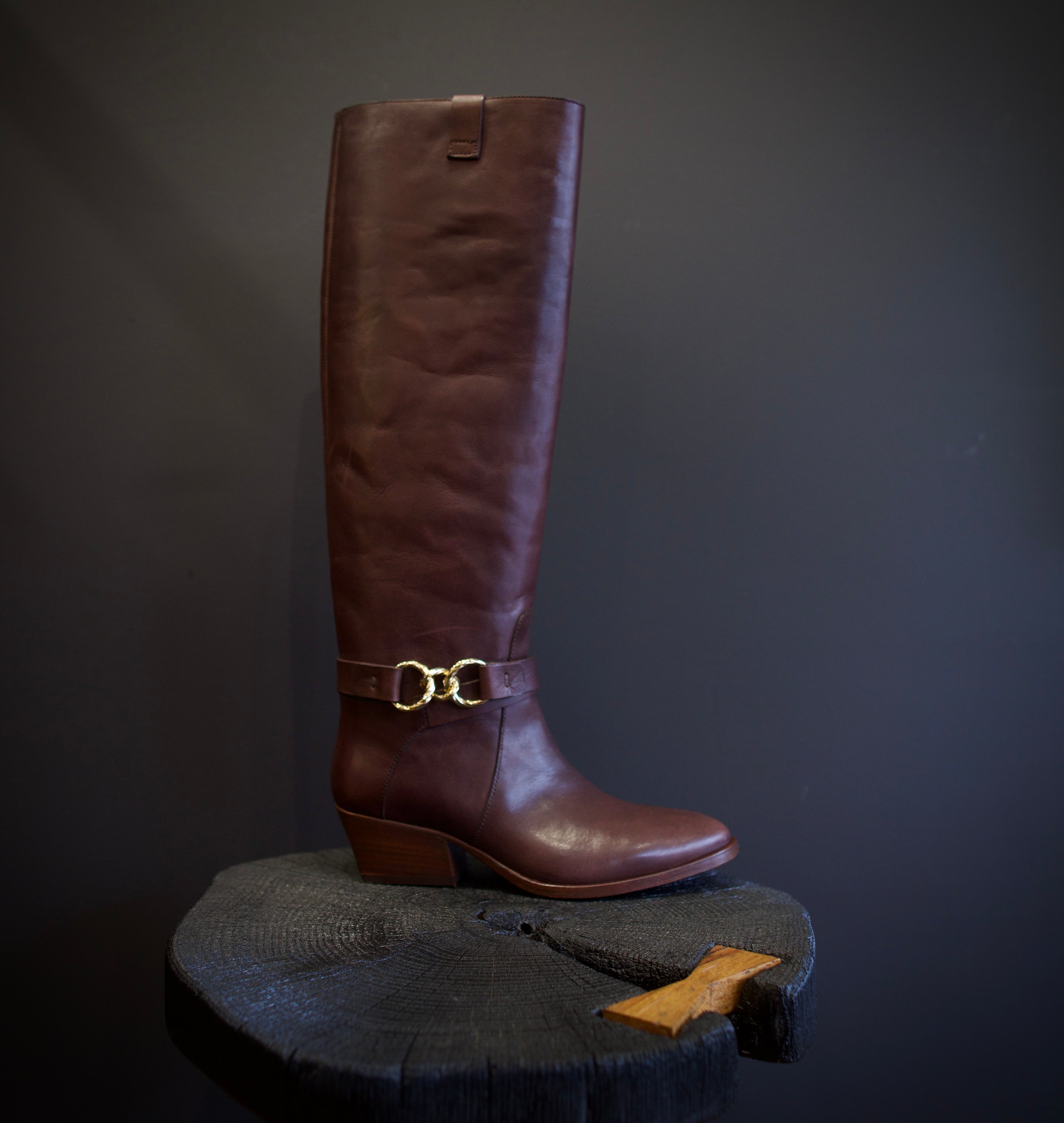 Image of the Ulla Johnson willow cowboy boot with a  knee-high length, pointed toe, and rests on a stacked block heel.