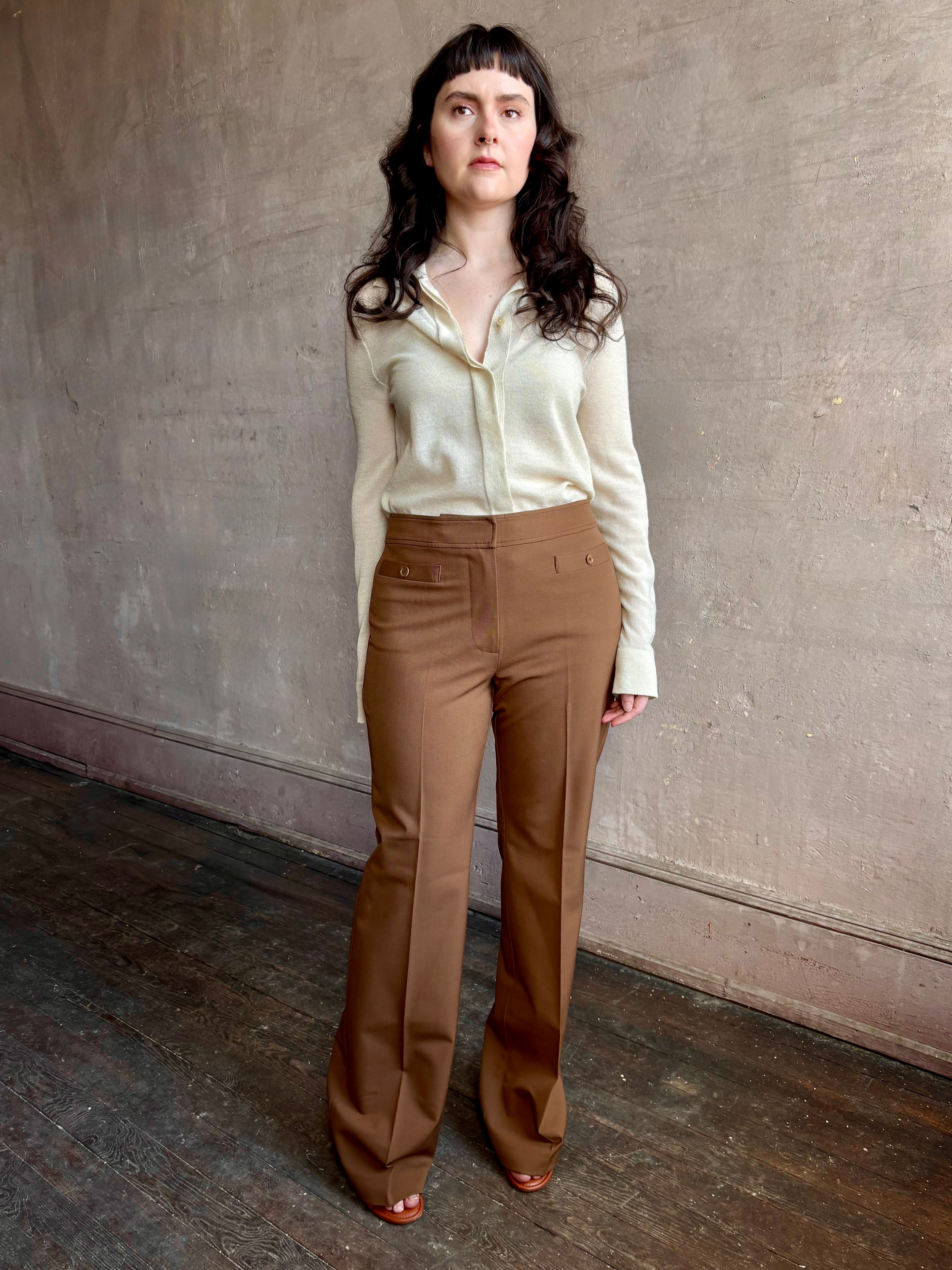 Image of woman wearing premium wool tailored blanca trousers by luxury designer Ulla Johnson Blanca in a neutral medium brown