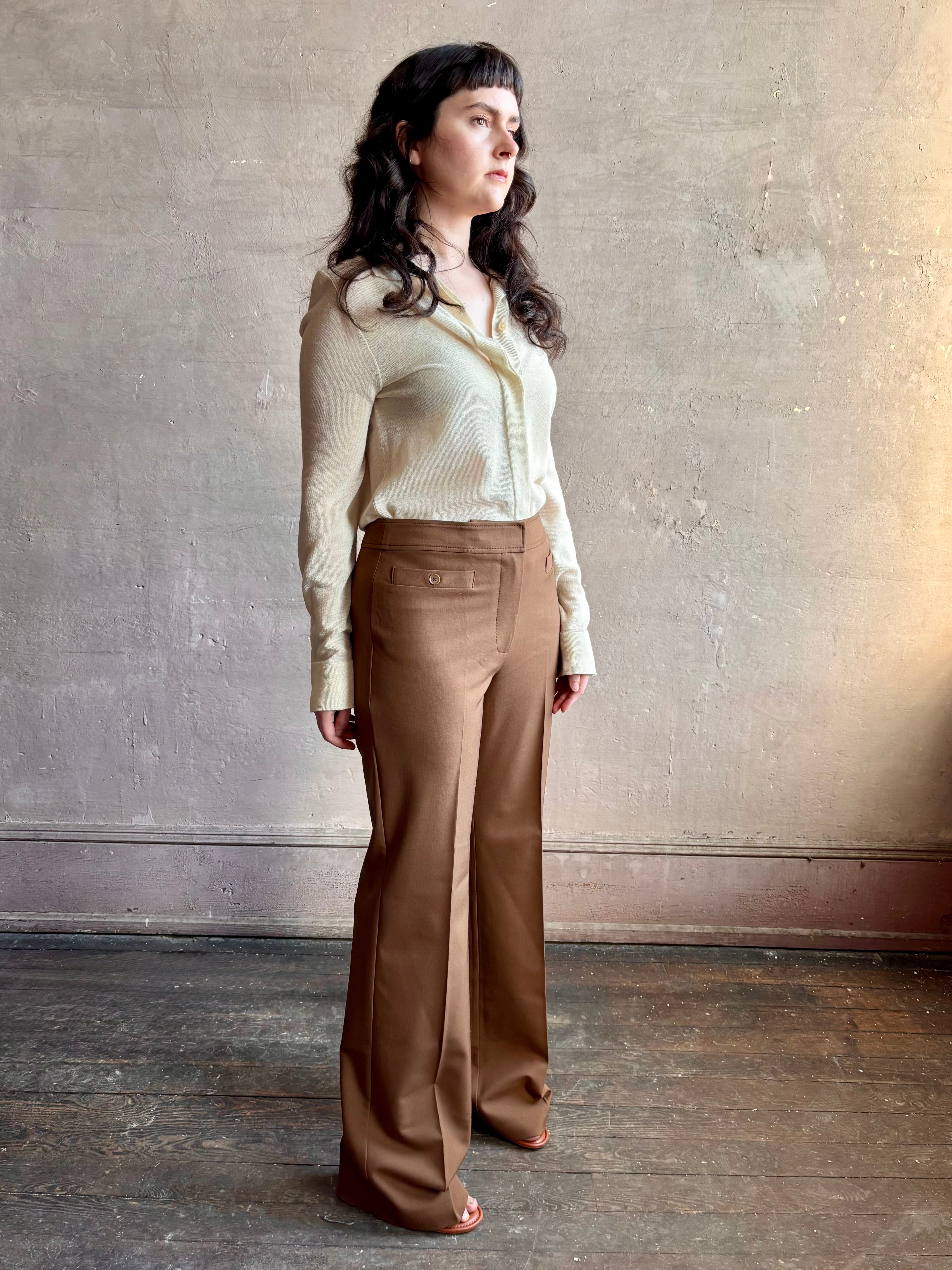 Image of woman wearing premium wool tailored blanca trousers by luxury designer Ulla Johnson Blanca in a neutral medium brown