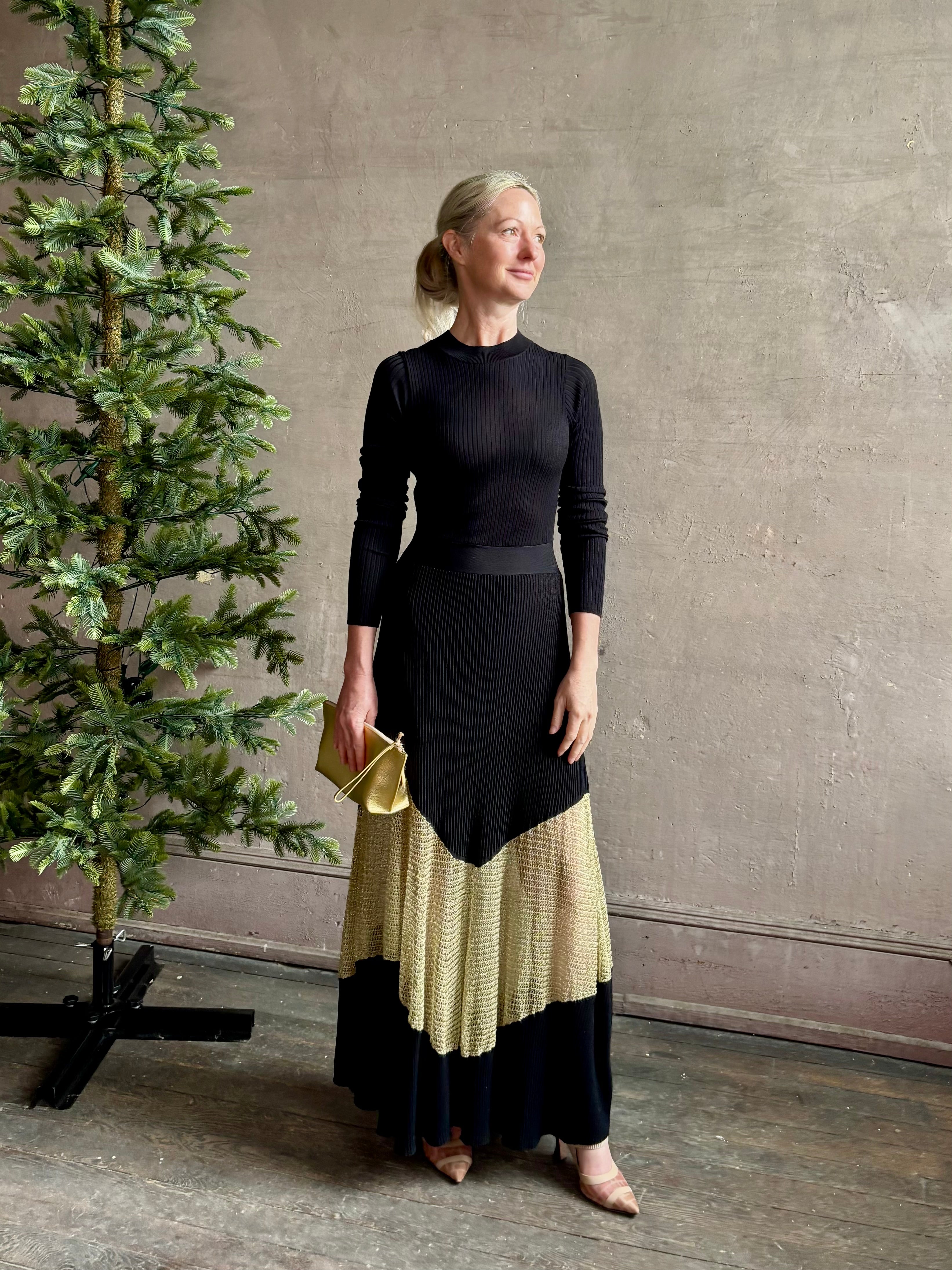 Image of woman wearing sophisticated Ulla Johnson Roanne knit maxi A-Line Dress with elegant sheer gold chevron detail and long sleeves