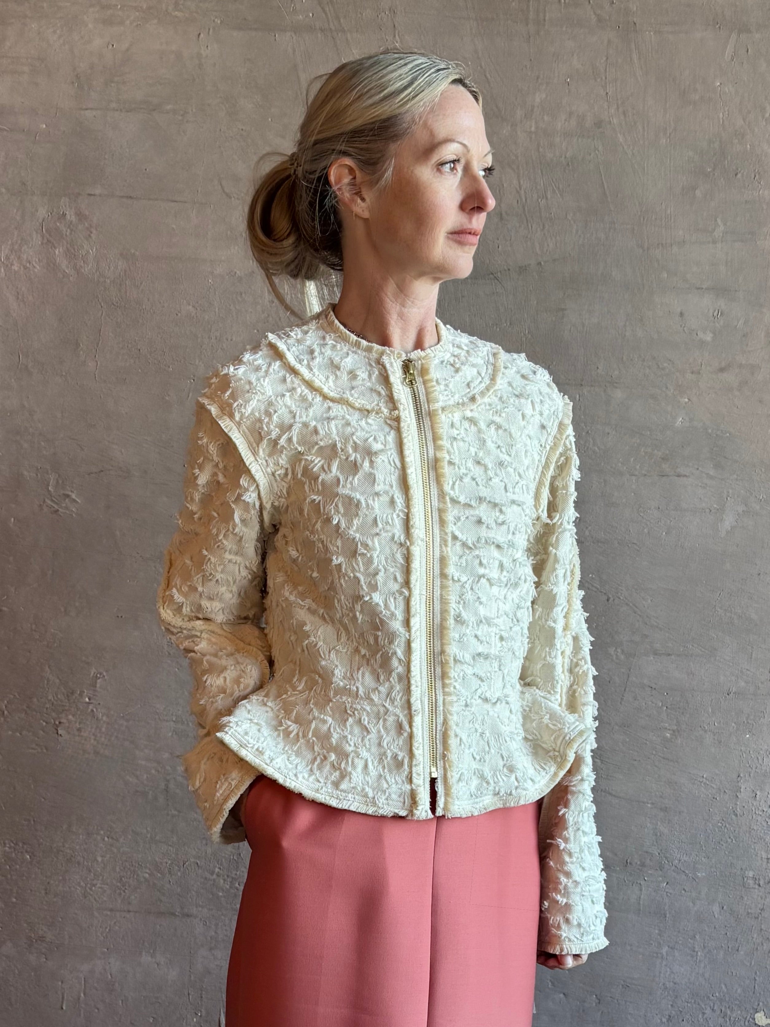 Image of woman wearing designer Ulla Johnson Rosalind tailored peplum Jacket in Premium Cotton with checkered fringe texture