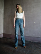 Mature woman wearing Vanessa Bruno Benito jeans with a zip fly, high rise, straight leg, full length medium wash