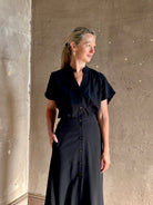 Woman wearing Vanessa Bruno classic button-front Cheryle maxi dress with open back detail short sleeve v-neck