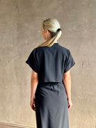 Woman wearing Vanessa Bruno classic button-front Cheryle maxi dress with open back detail short sleeve v-neck