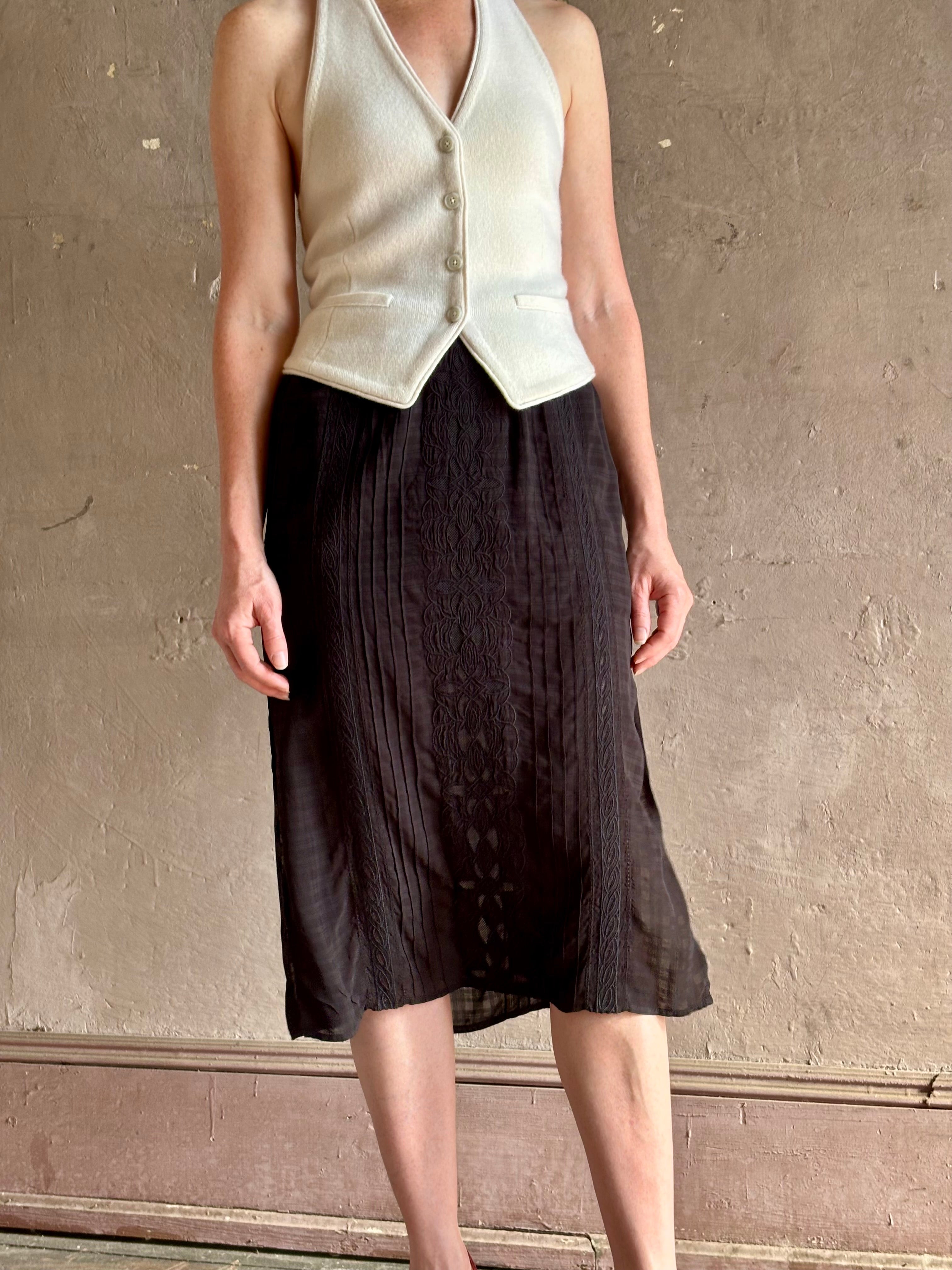 woman wearing Vanessa Bruno midi skirt semi-sheer jacquard black-on-black plaid delicate eyelet and pintucking
