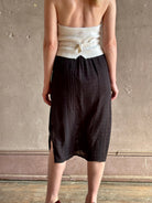 woman wearing Vanessa Bruno midi skirt semi-sheer jacquard black-on-black plaid delicate eyelet and pintucking