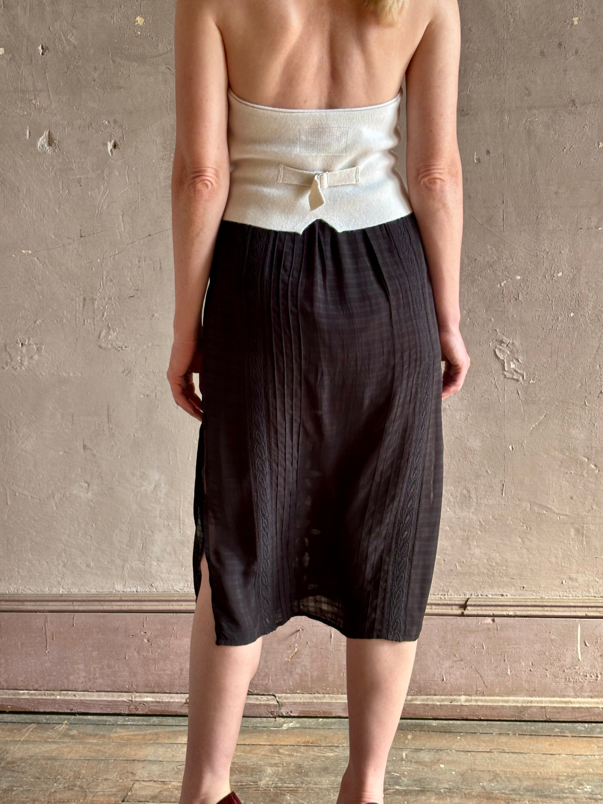 woman wearing Vanessa Bruno midi skirt semi-sheer jacquard black-on-black plaid delicate eyelet and pintucking