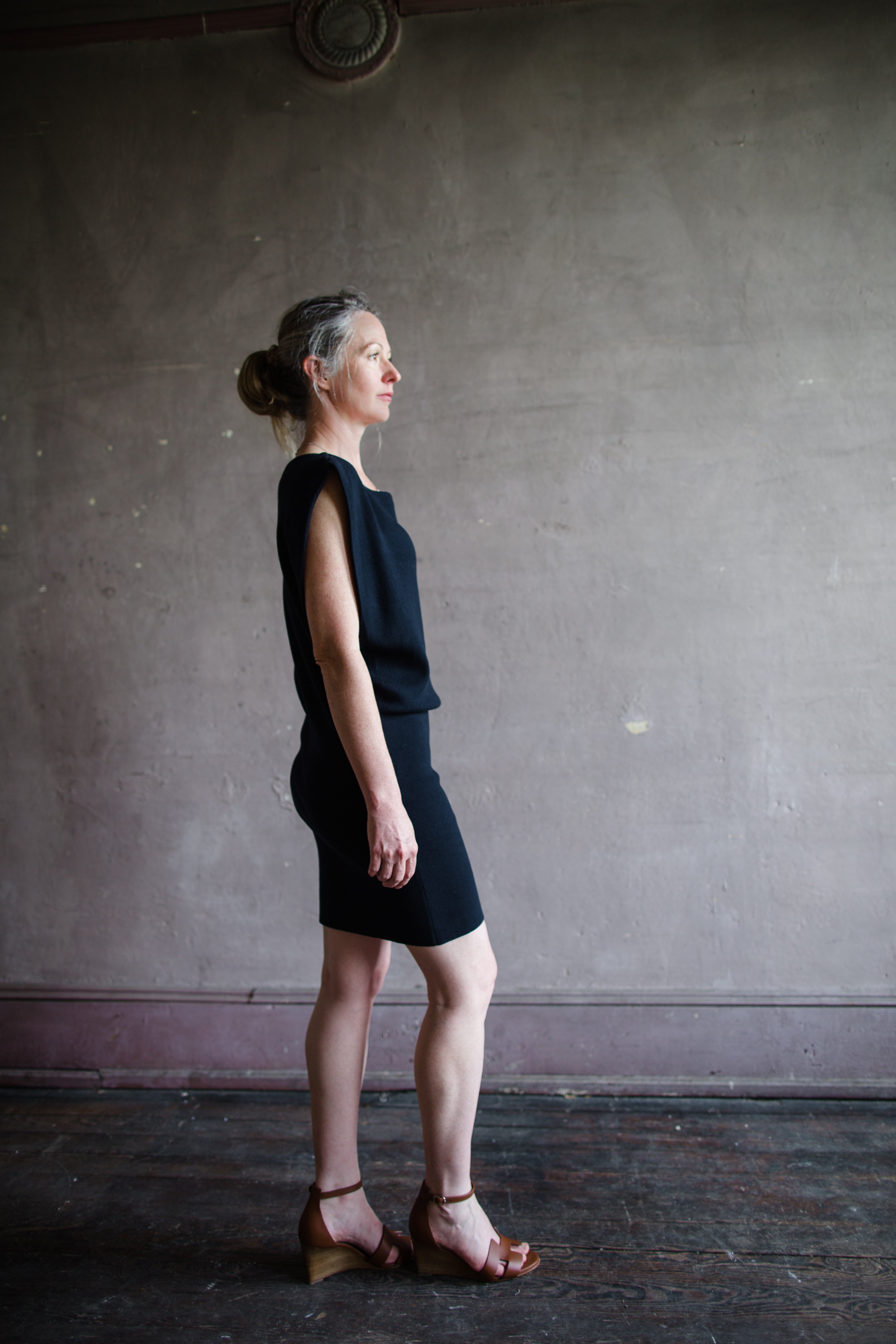 Mature woman wearing the Dorotea dress by Vanessa Bruno with boatneck blouson top fitted skirt in navy blue