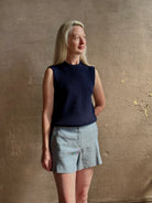 Woman wearing Vanessa Bruno Elisam elevated mid-rise tailored blue and white pinstripe short naturally breathable 
