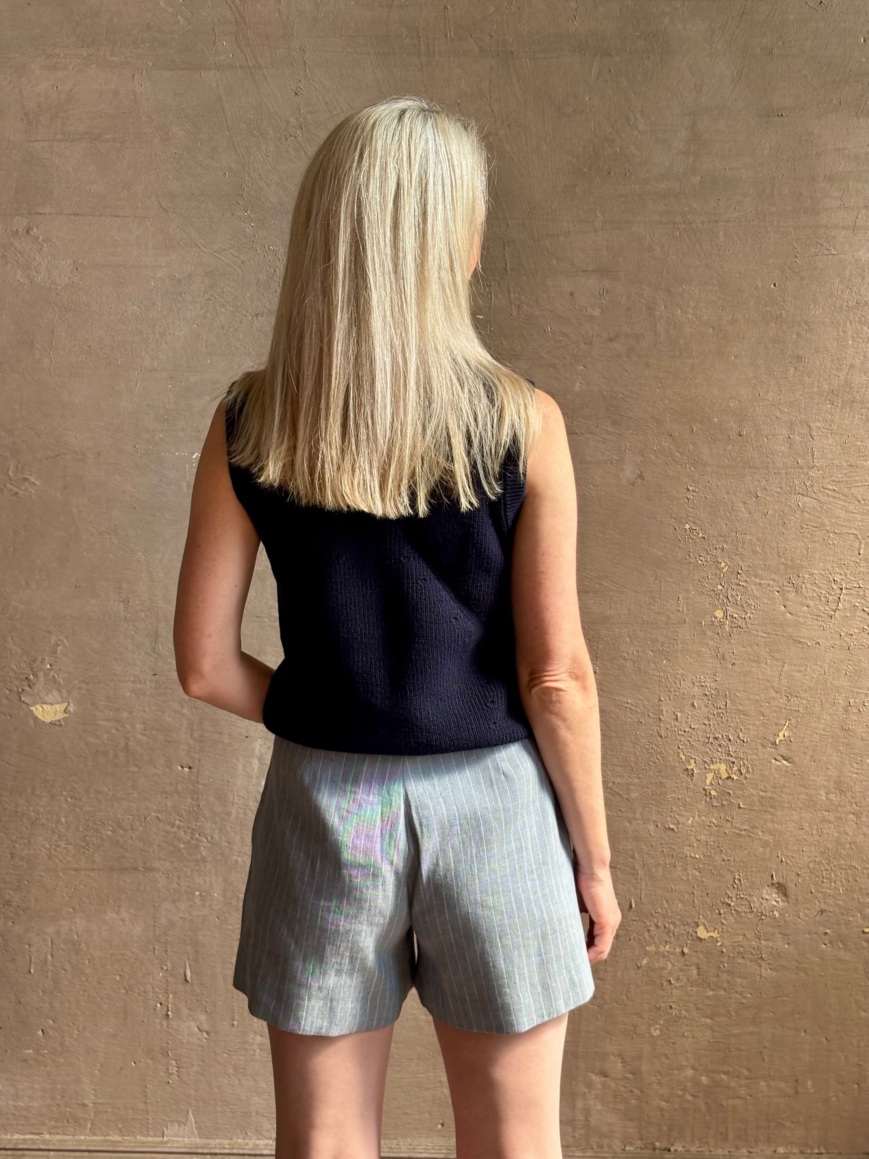 Woman wearing Vanessa Bruno Elisam elevated mid-rise tailored blue and white pinstripe short naturally breathable 