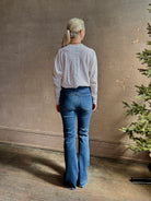 Mature woman wearing VERONICA BEARD BEVERLY JEANS medium wash Women's Cotton Blend High-Rise Flared Leg