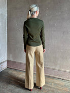 Mature womanwearing a dark green long-sleeve ribbed cotton henley top designer Veronica Beard Cordis Long Sleeves