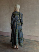 Mature woman wearing designer Veronica Beard Skye Dress with cuffed long sleeves and fluid asymmetrical hem