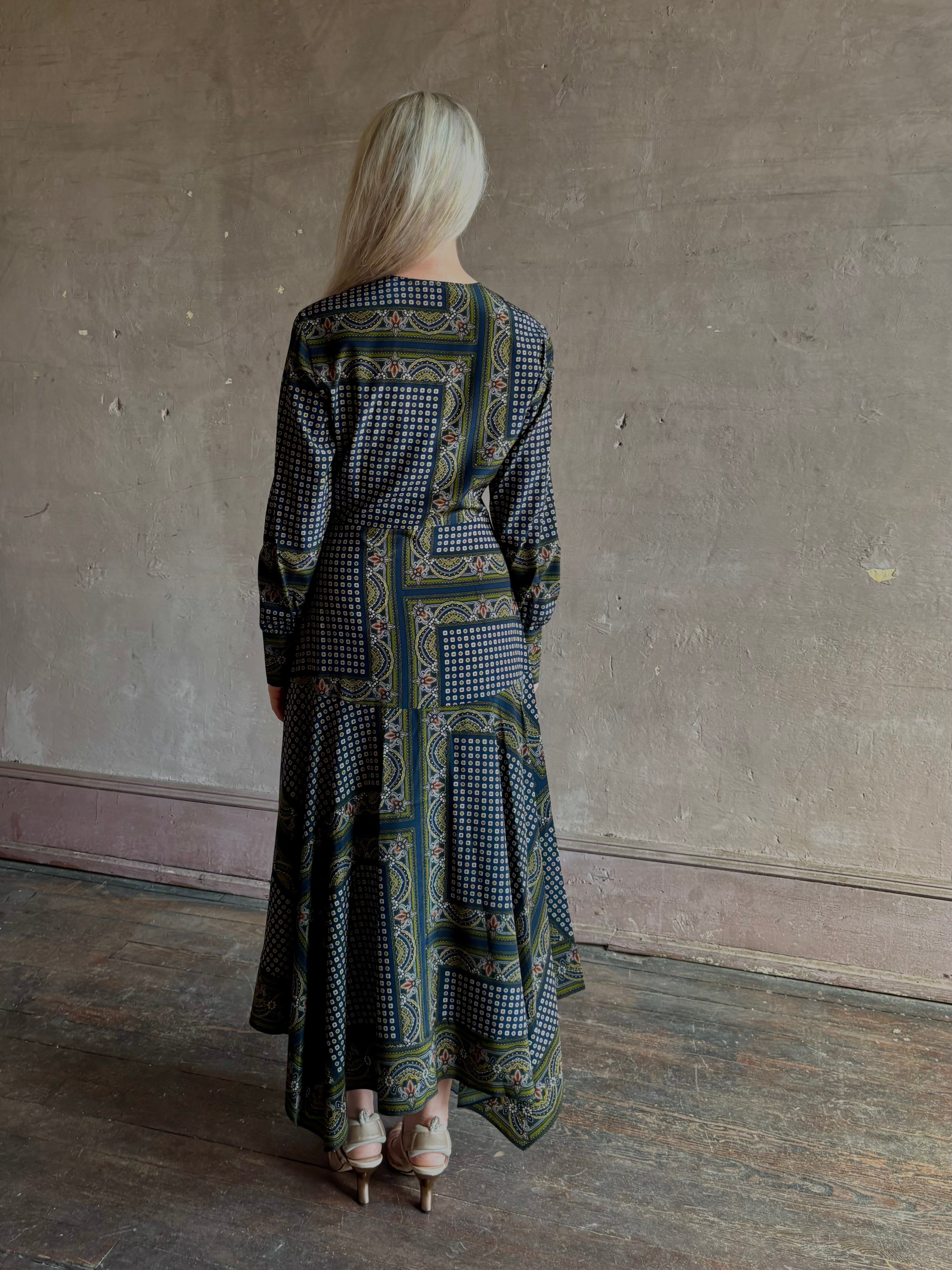 Mature woman wearing designer Veronica Beard Skye Dress with cuffed long sleeves and fluid asymmetrical hem