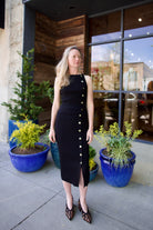 woman wearing Veronica Beard black knit Tanner Skirt with gold buttons leg vent comfy stretchy ribbed texture
