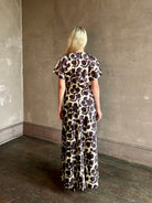 Mature woman wearing designer Veronica Beard V-Neck Redgrave Dress Ecru Multi short sleeves sheath maxi occasion-ready 