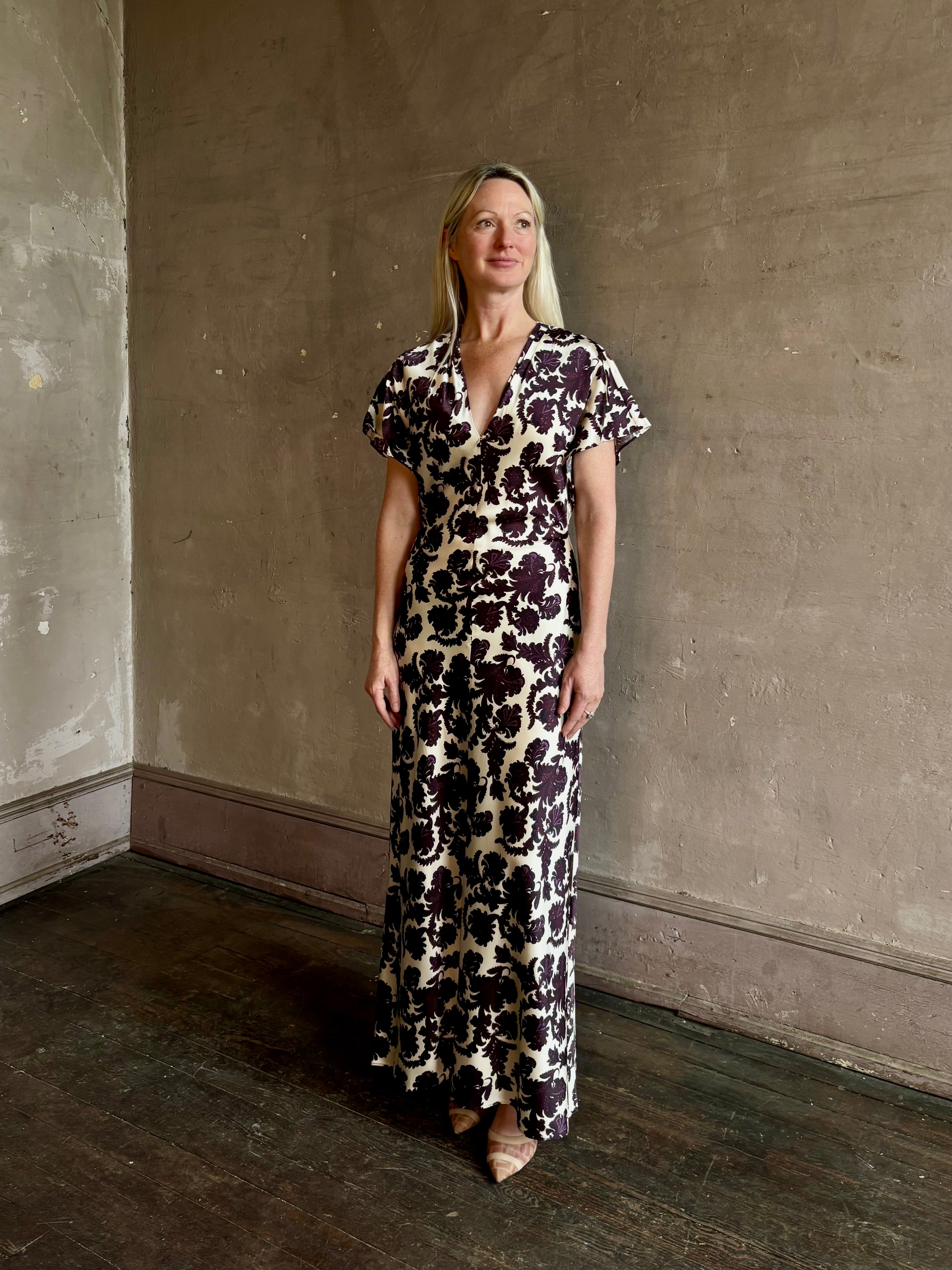 Mature woman wearing designer Veronica Beard V-Neck Redgrave Dress in Ecru Multi sheath maxi purple floral print Elongating, occasion-ready 