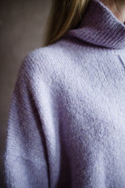 Image featuring a woman wearing the Balade yack, alpaca & wool sweater by Vanessa Bruno with a high neckline with a front seam and oversized fit in lilac color.