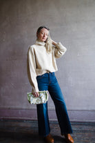 Image featuring a woman wearing the Ballerine yack and wool sweater by Vanessa Bruno with a high neckline and relaxed fit in ecru color.