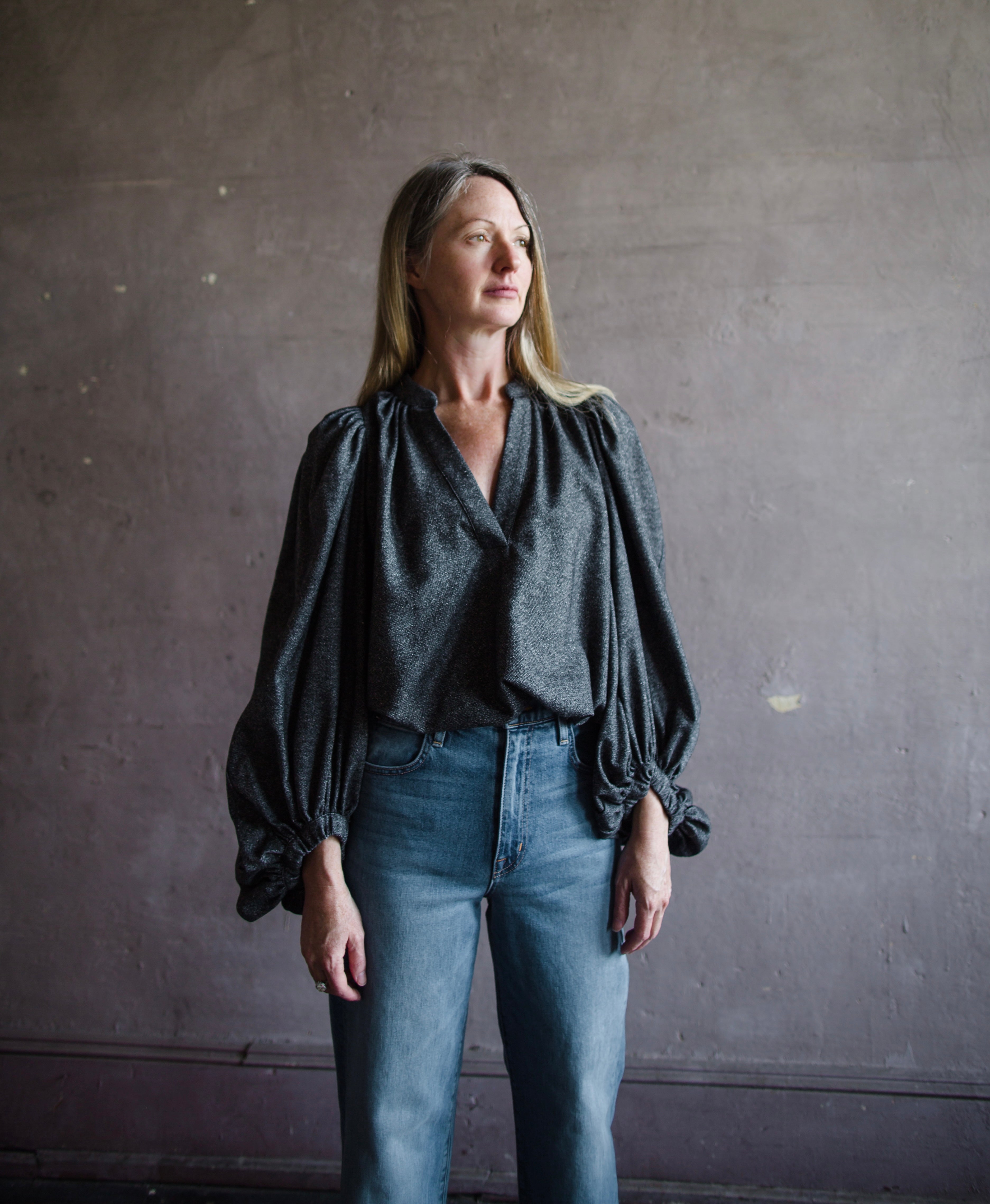 Front view of woman wearing Vanessa Bruno bell poet blouse in anthracite gray wool blend