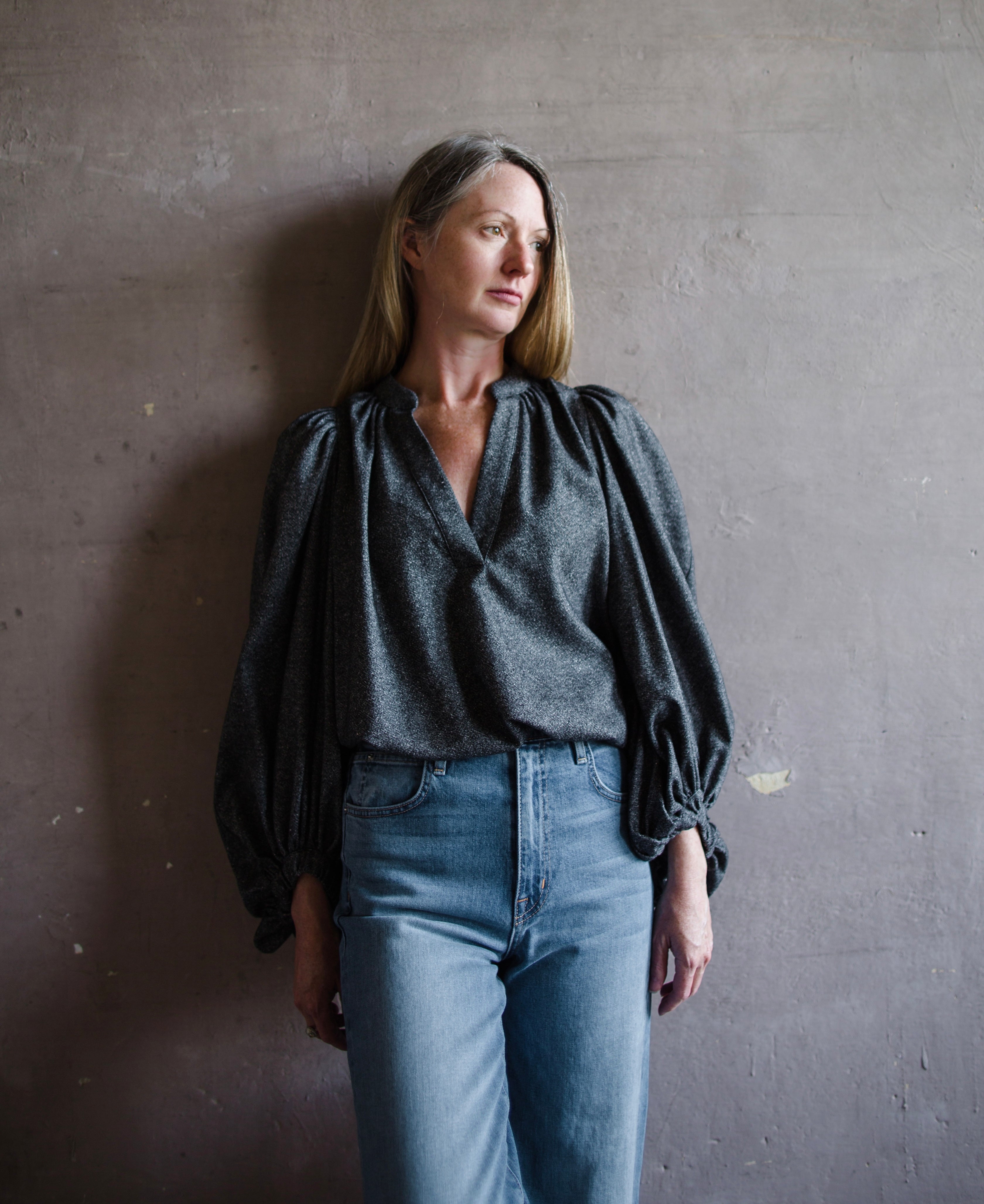 Front view of woman wearing Vanessa Bruno bell poet blouse in anthracite gray wool blend