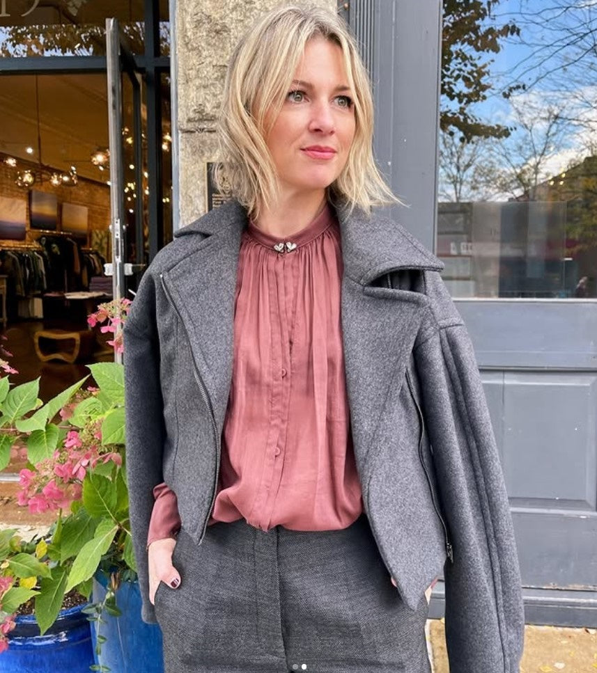 Mature woman wearing Vanessa Bruno Bless jacket asymmetrical zipper, full sleeve cropped in dark grey.