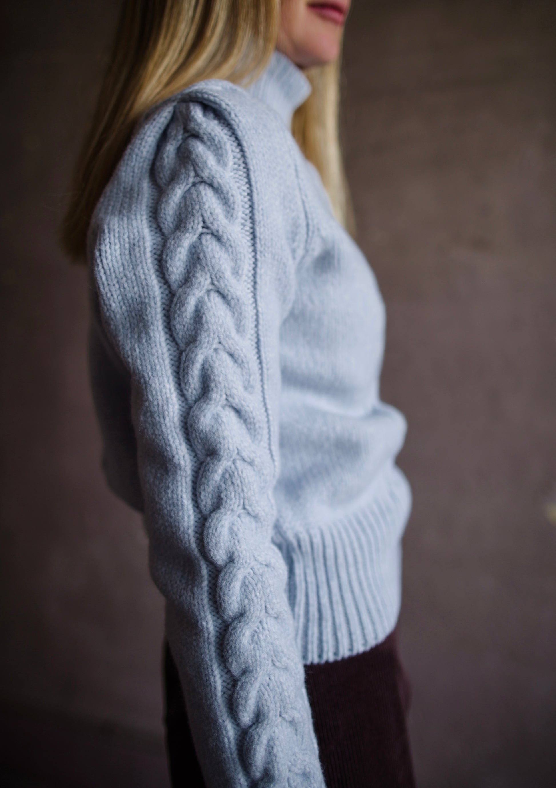 Side view of Woman wearing Vanessa Bruno dabatha cable knit turtleneck sweater in shade azure merino wool blend