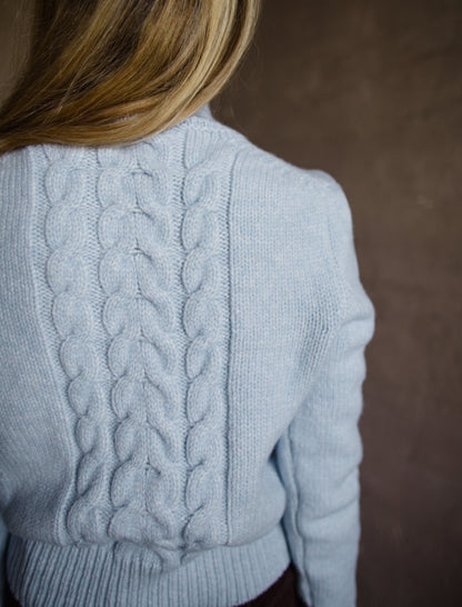 Back view of Woman wearing Vanessa Bruno dabatha cable knit turtleneck sweater in shade azure merino wool blend