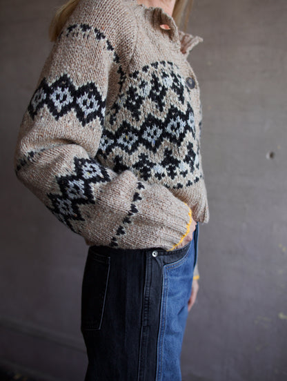 Image featuring a woman wearing the Damas khaki cardigan by Vanessa Bruno in black and baby blue argyle pattern with small yellow detail trim at sleeve.