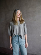 Image featuring a woman wearing the taupe Deliah sweater by Vanessa Bruno with a crew neckline, dolman sleeve and a relaxed fit in a yak wool blend.