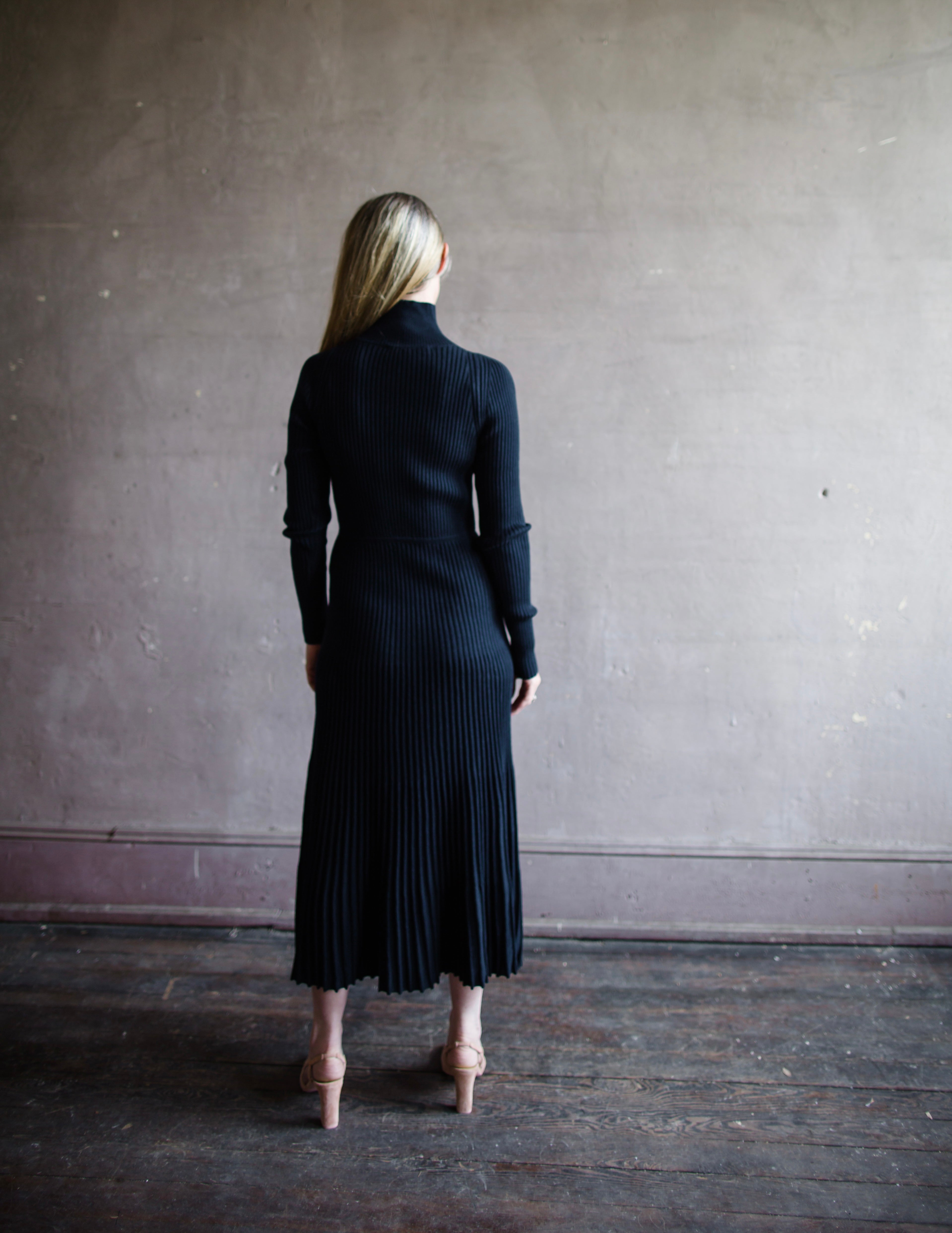 Back view Woman wearing Vanessa Bruno Divana Ribbed knit dress in Navy wool cotton blend