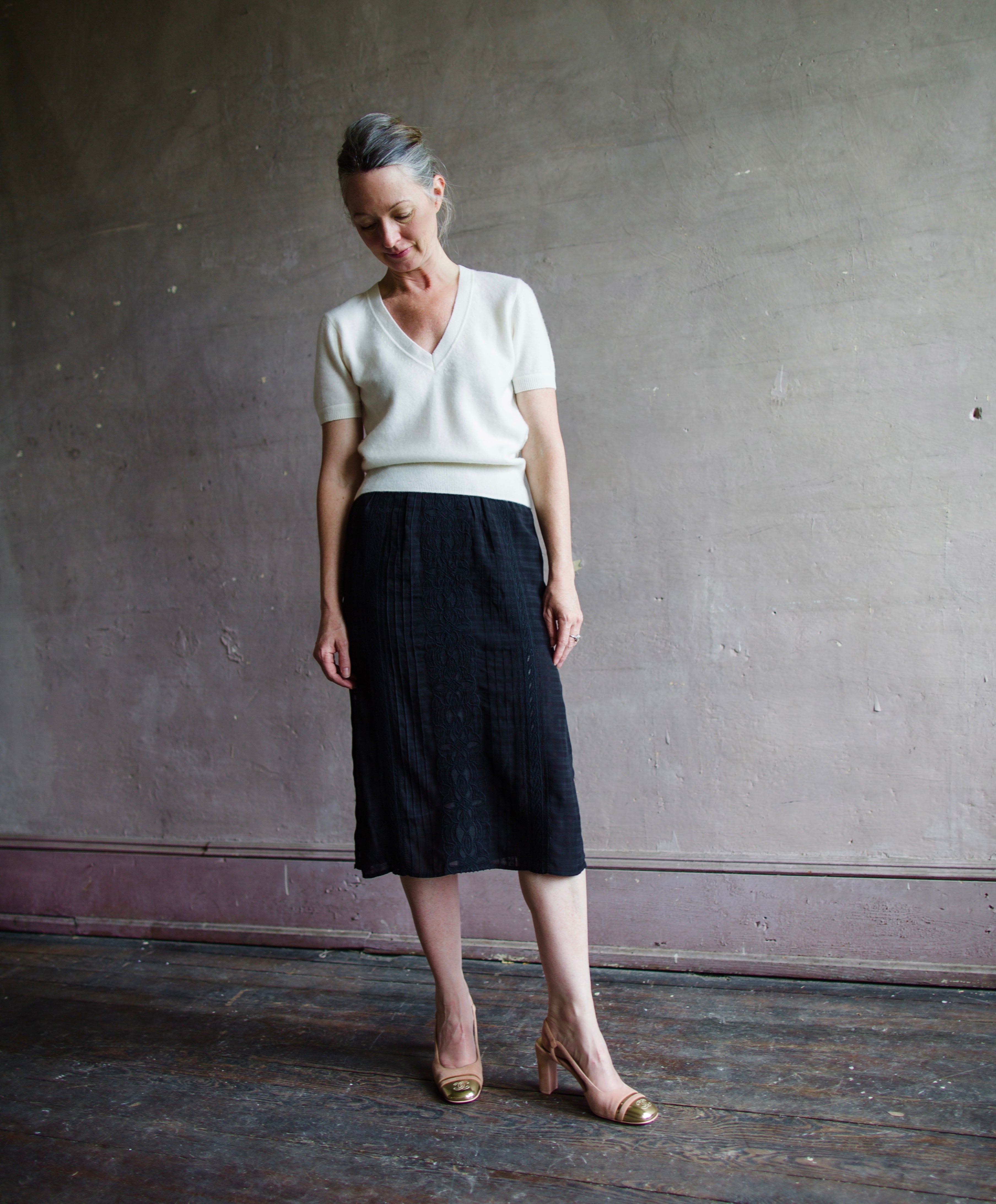 Image featuring a woman wearing the Dori skirt by Vanessa Bruno with a semi-sheer jacquard viscose textured and layered fit, side slits and an elastic waist in black.