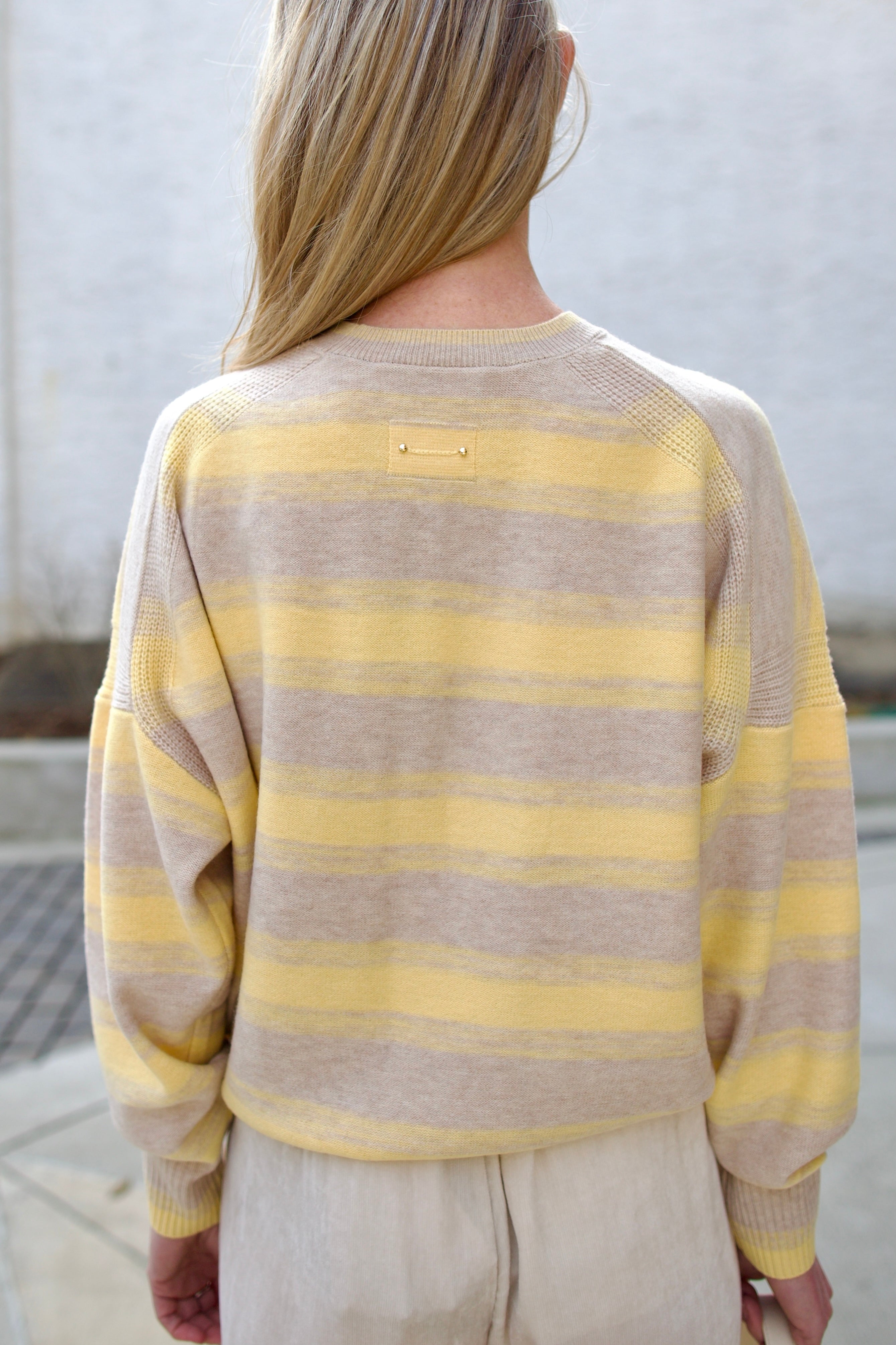 back image of a woman wearing the vanessa bruno eugenie striped sweater