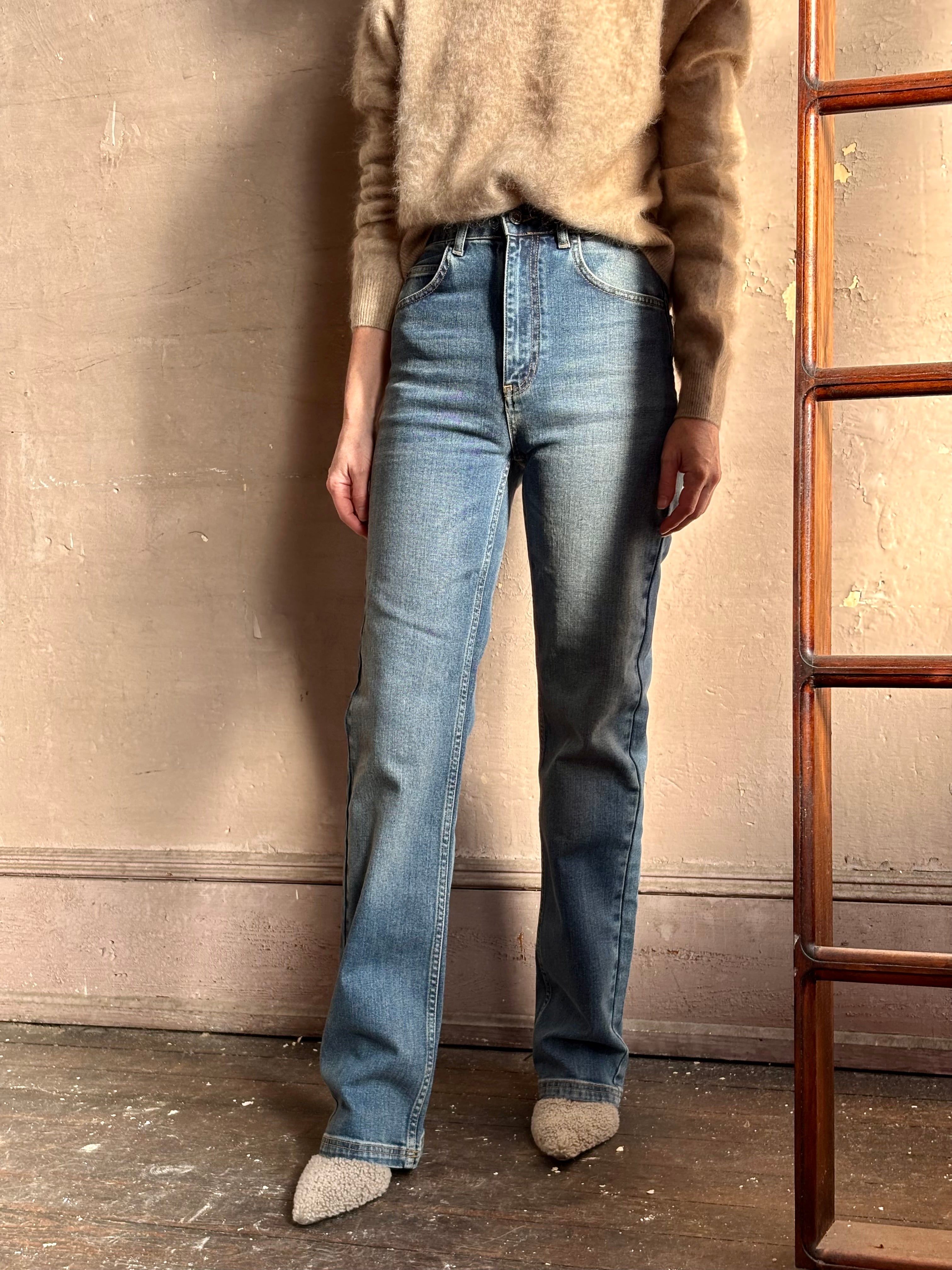 Mature woman wearing French made straight-leg cotton jeans by Vanessa Bruno high waisted in medium wash full length