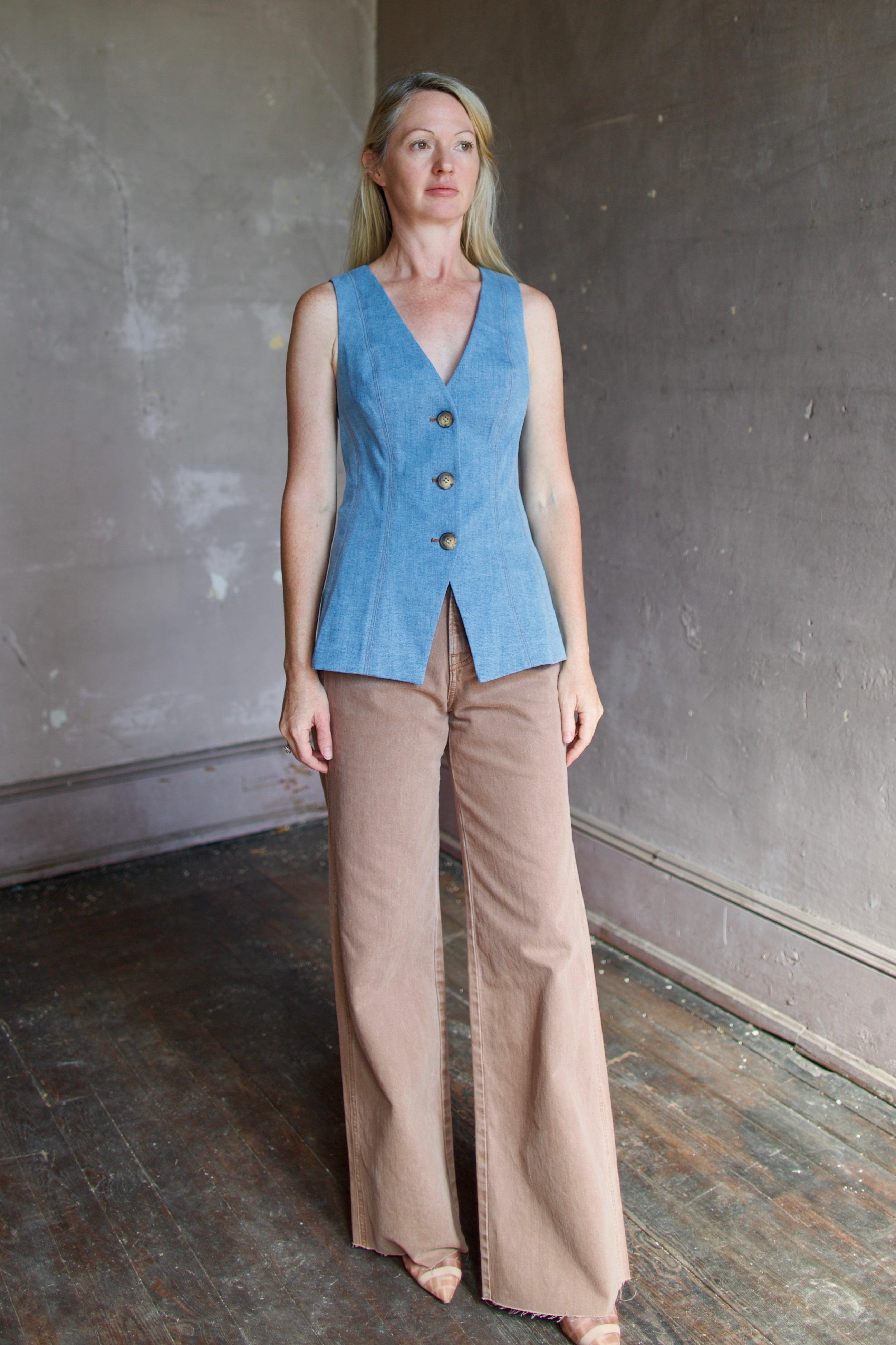 Model wearing the Avalina blue mirage vest and tan Taylor
high rise denim by contemporary designer Veronica Beard