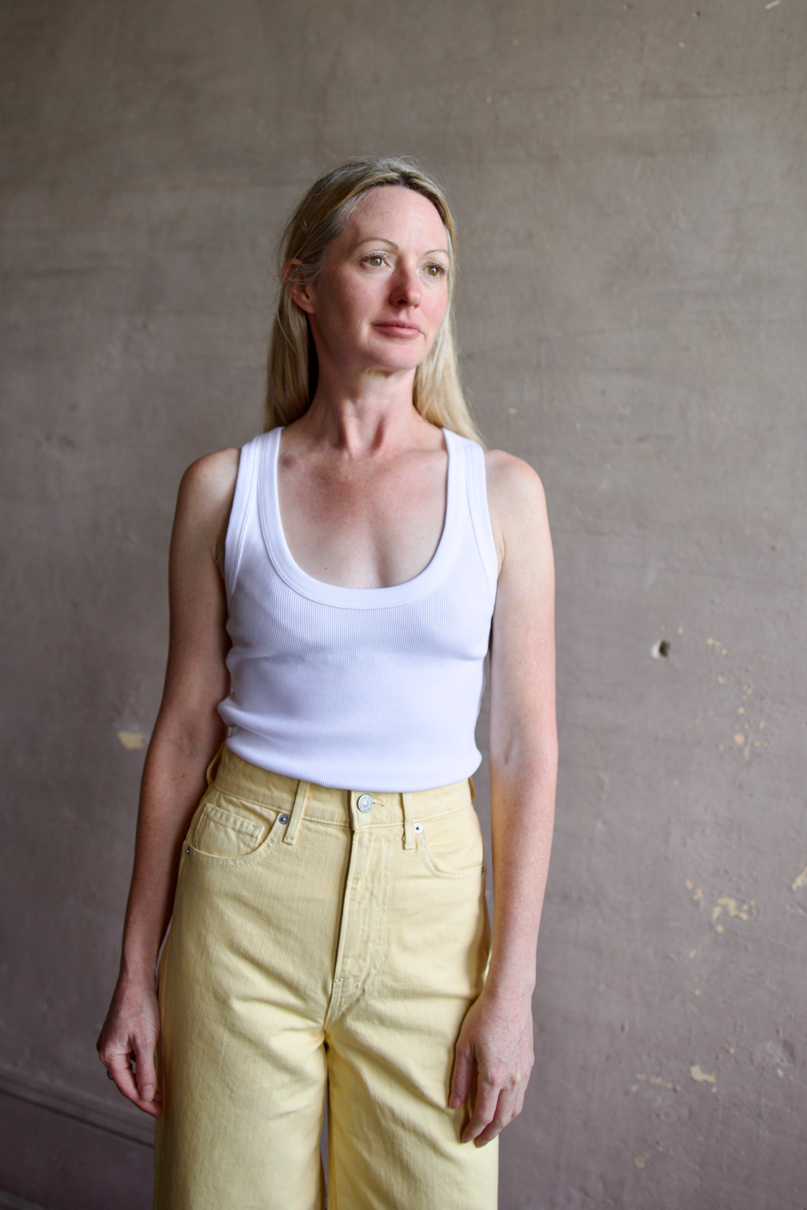 Image of a model wearing designer Veronica Beard Birke white tank top in premium cotton blend with ribbed texture and classic scoop neckline