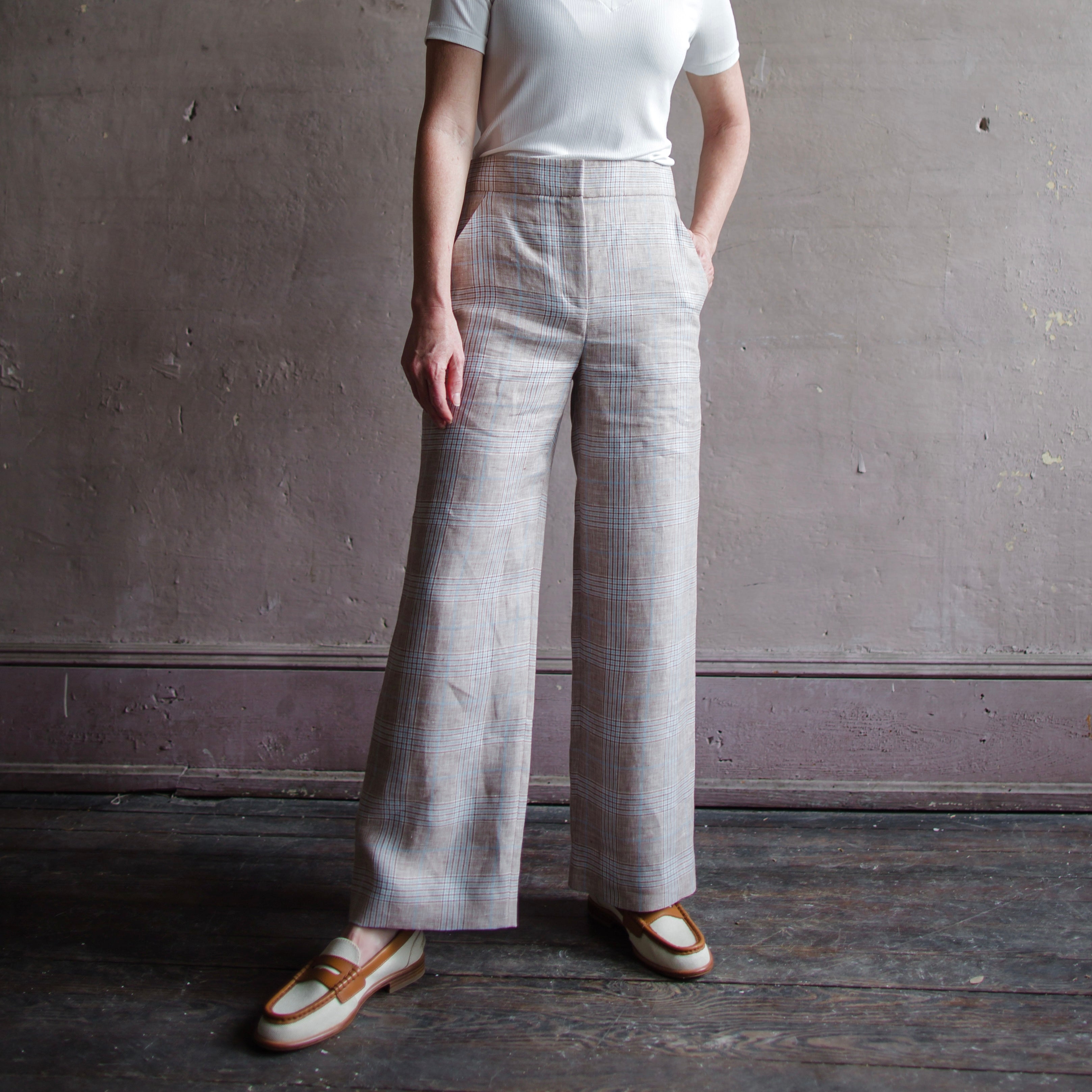 Image featuring a woman wearing the Brixton linen pants from Veronica Beard with a flat front, high-rise, wide-leg design in a cropped silhouette with side slit pockets.