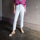 Image featuring a woman wearing the Veronica Beard Carly kick-flare jean is their best selling jean featuring a high-rise, kick flare, raw hem, cropped length denim.