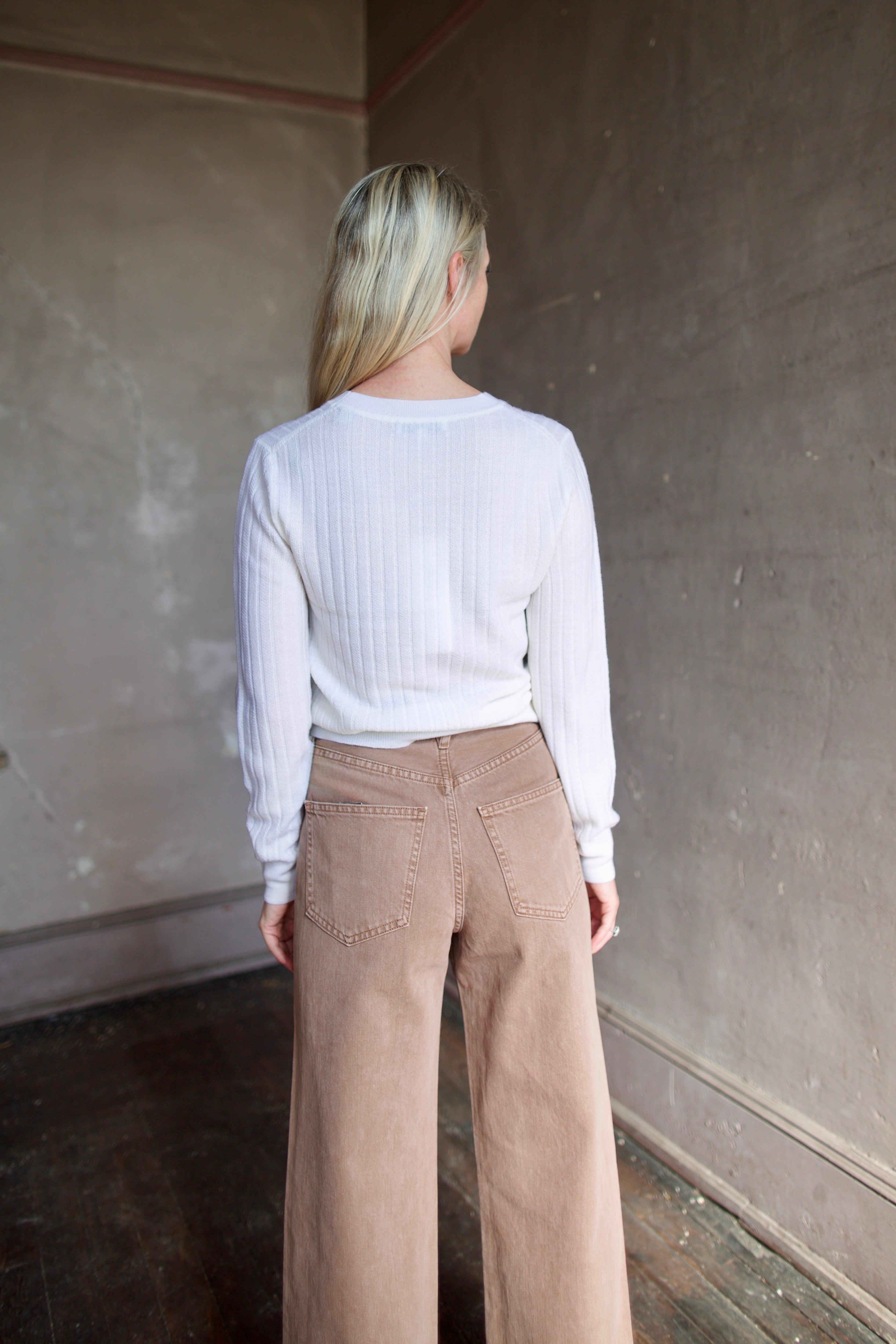 Model wearing timeless Veronica Beard premium wool cheval pullover in ivory with lightweight wide ribbed texture, long sleeves, and crew neck