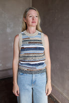 Model wearing a sleeveless, multicolored intricately woven knit top Jerrel in whisky  by contemporary designer veronica beard