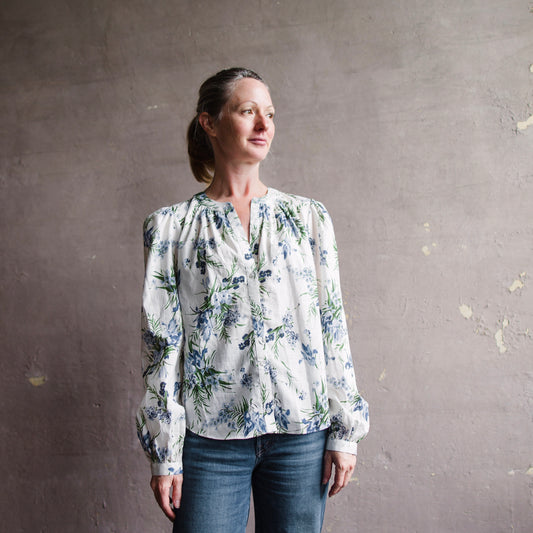 Image featuring a woman wearing the Ashlynn cotton blouse by Veronica Beard with a floral print and airy blouson sleeves. 