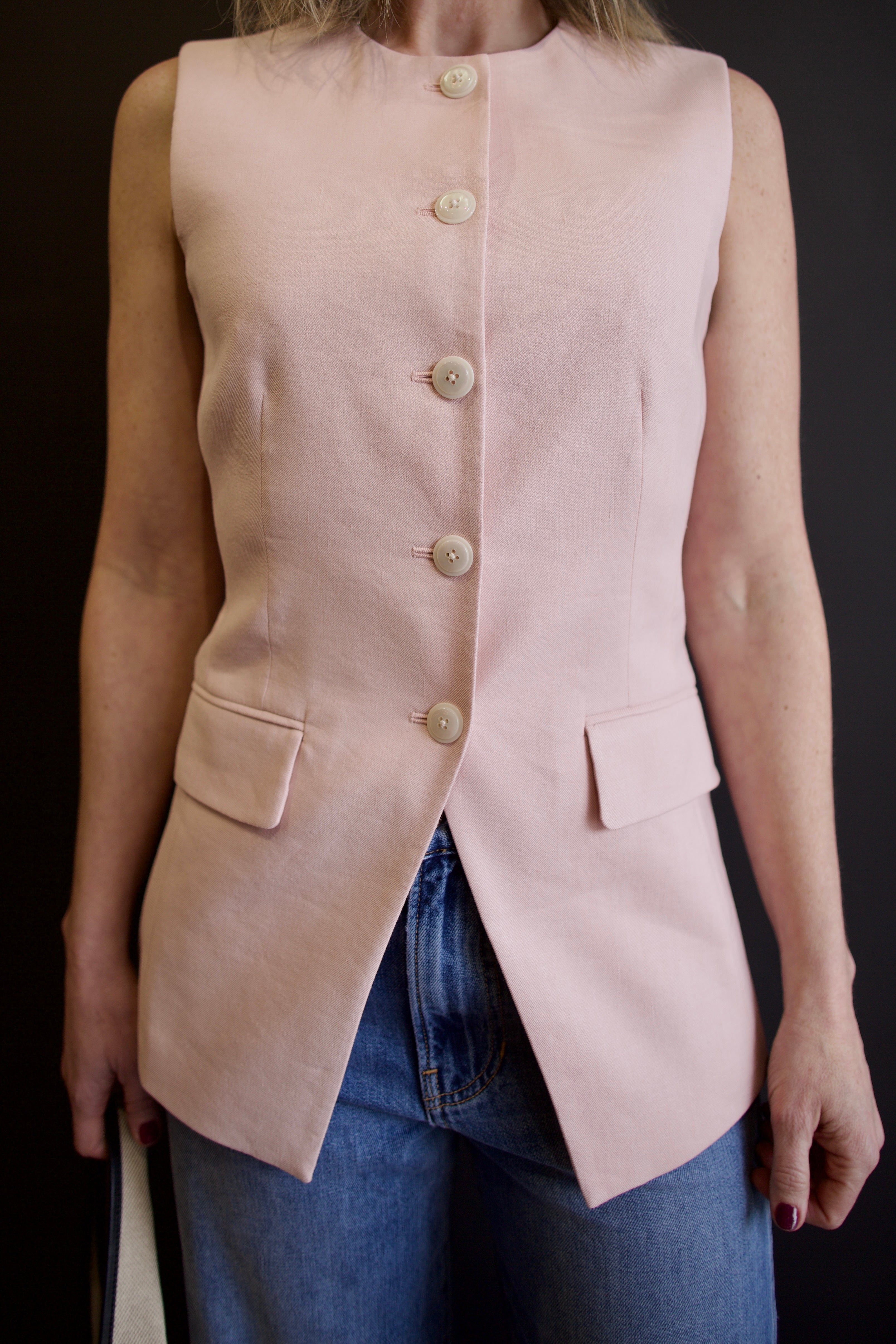 Image of a woman wearing Veronica Beard Lois Vest with button front closure in refined contemporary tailored design perfect for layering 