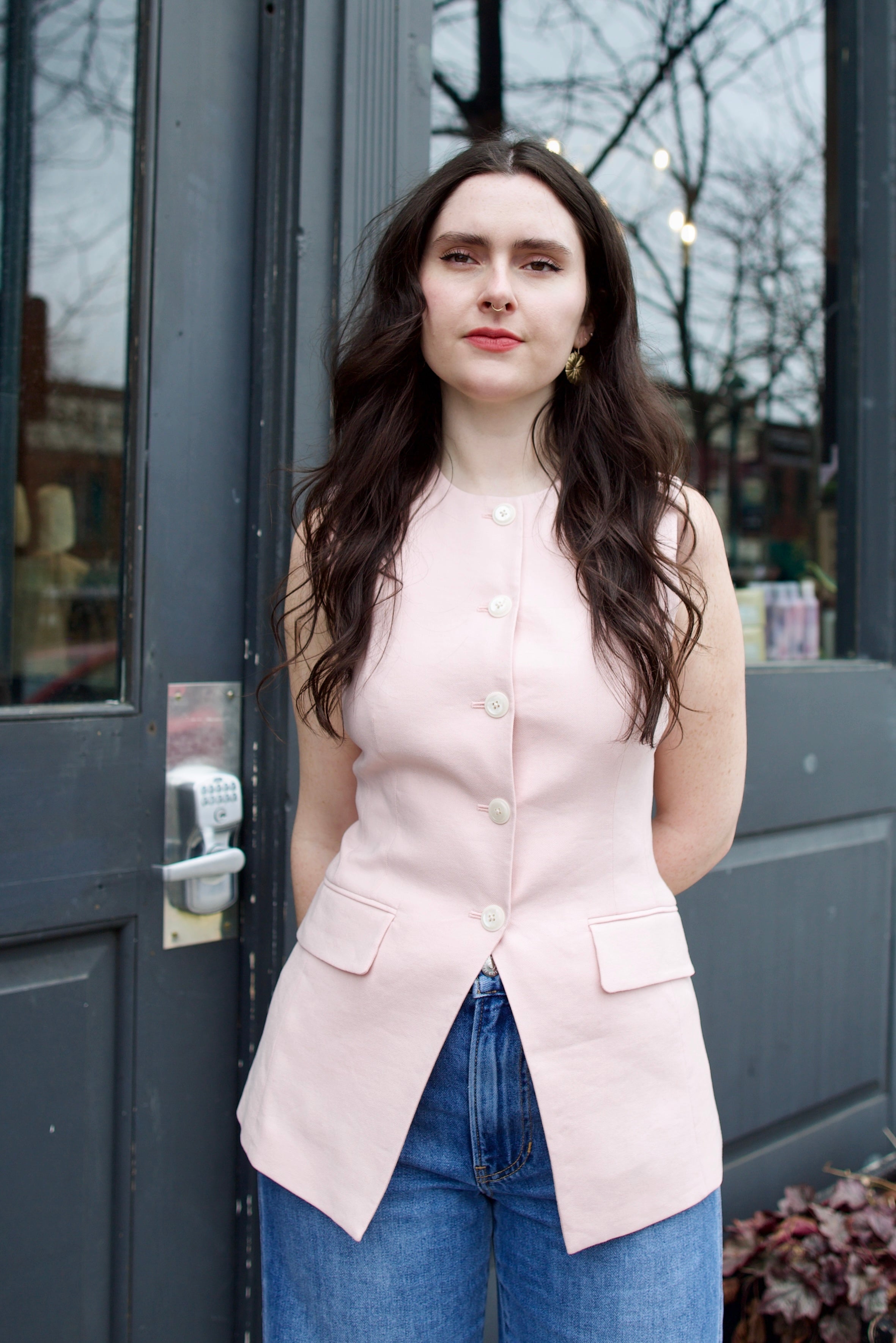 woman wearing Veronica Beard Lois Vest  button front closure tailored design sleeveless vest with front pocket flaps crew neck light pink