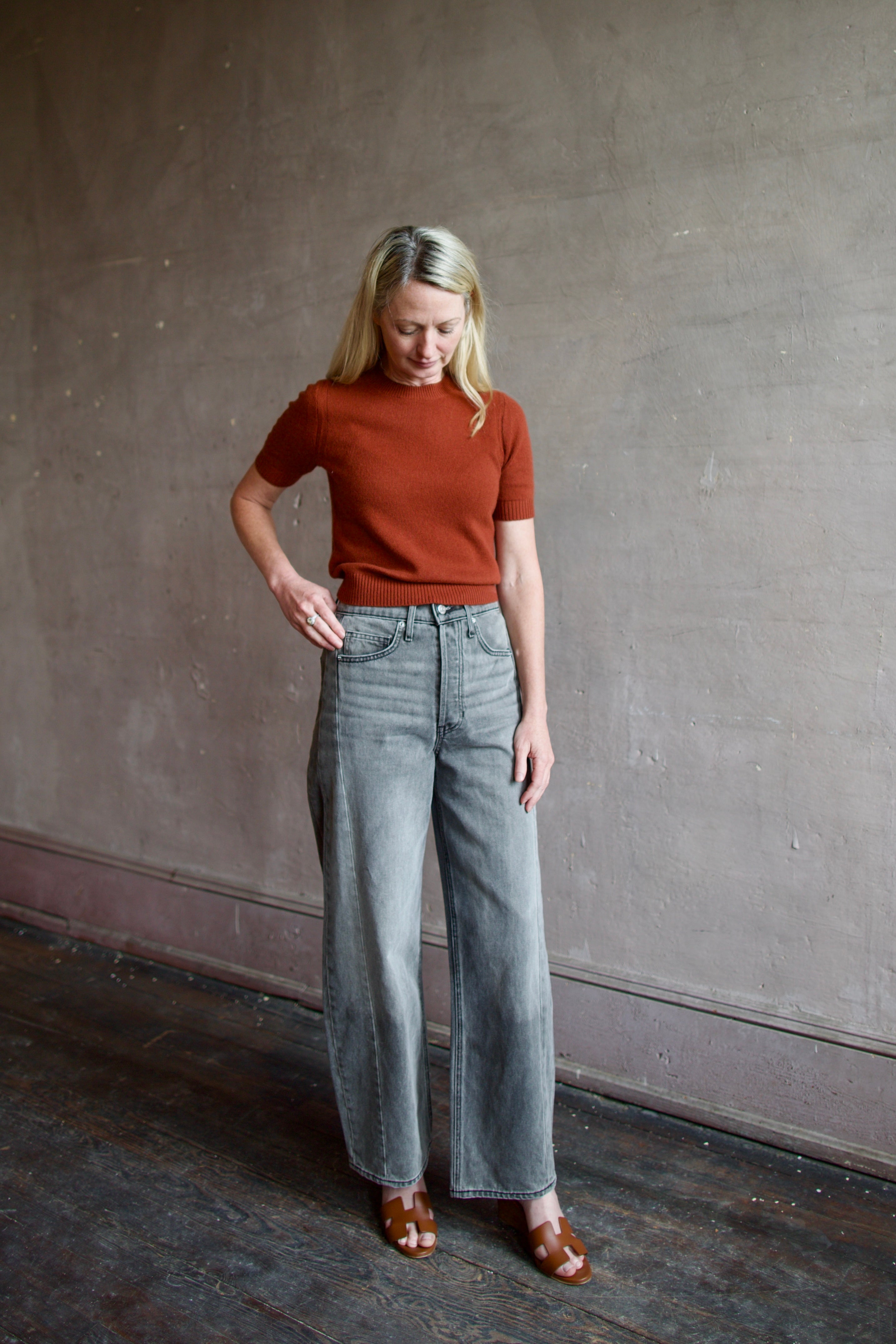 Mature model wearing designer brand Veronica Beard high rise Ryder grey barrel denim fabricated with rigid cotton 