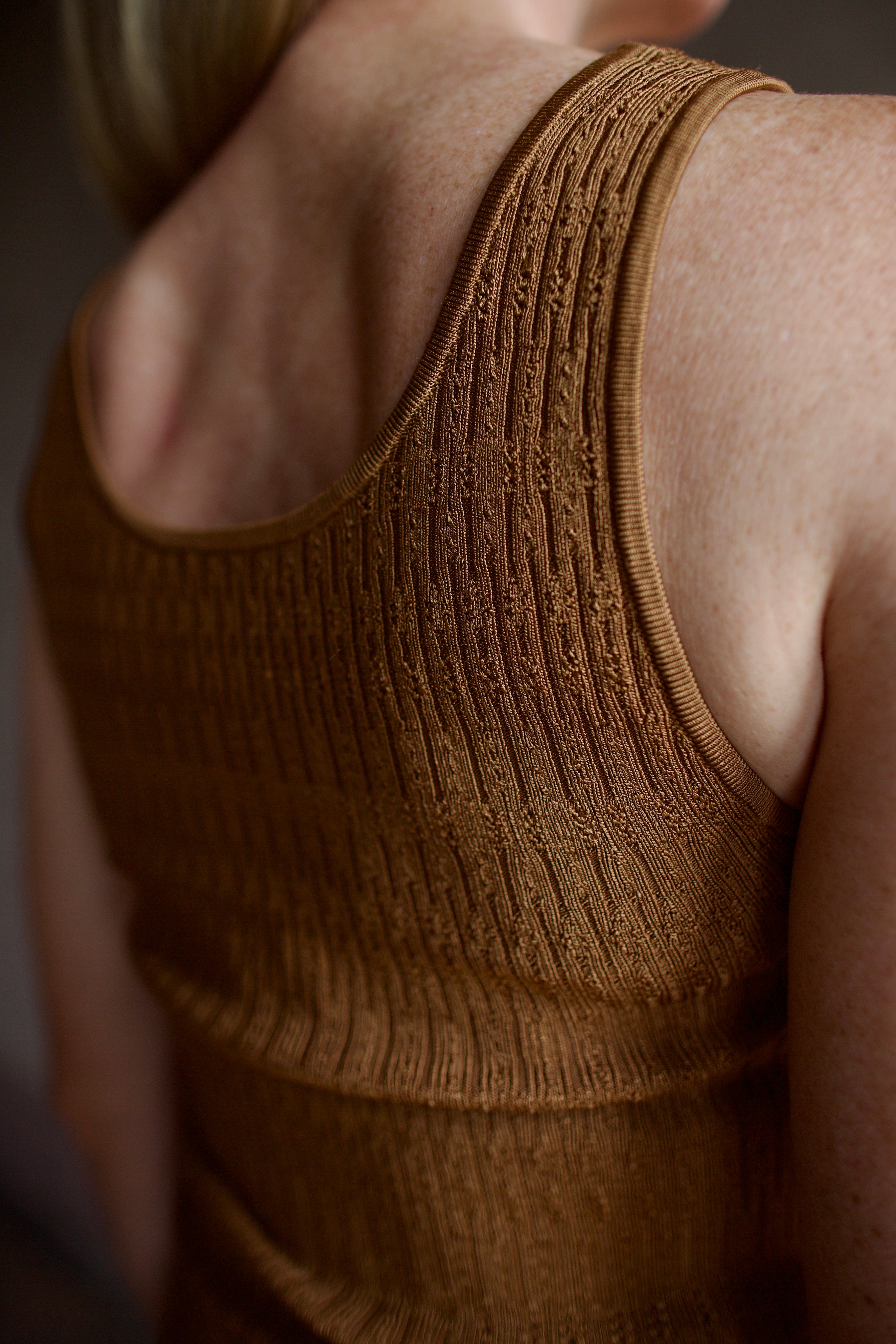 Model wearing premium  designer Veronica  Beard Sandra Tank with quality texture and scoop neck in a neutral copper colorway